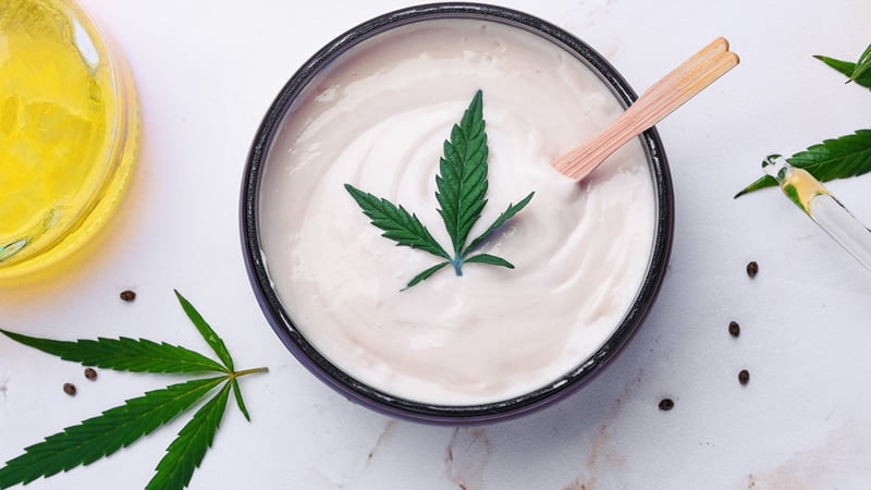 CBD Cream and CBD Oil with hemp leaves in white background