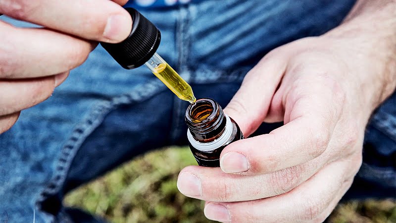 a man taking CBD oil