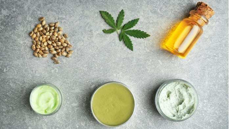 CBD Oil Hemp Balm Hemp Seeds and Hemp Leaves on the Surface