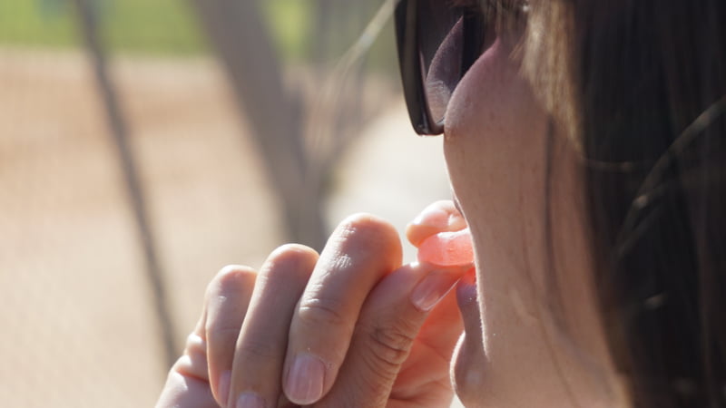 a girl eating cbd gummies