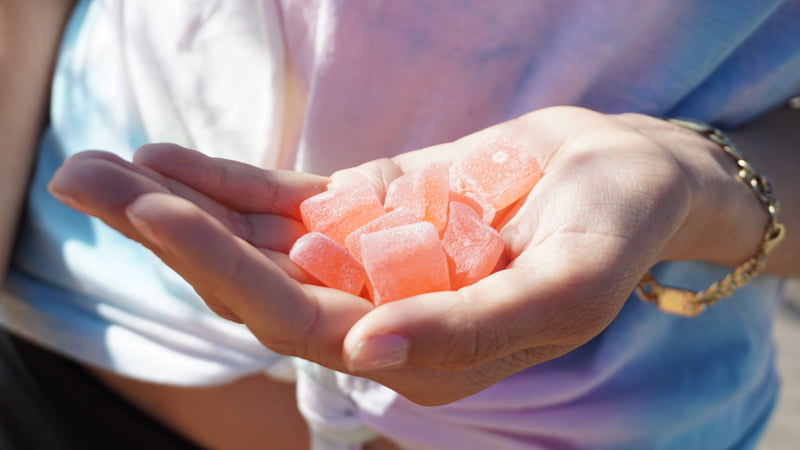 a women holding hemp infused gummies on her hand