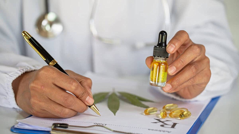 image of a doctor holding Delta 8 THC Tincture while writing a prescription with a hemp leaf and capsules 