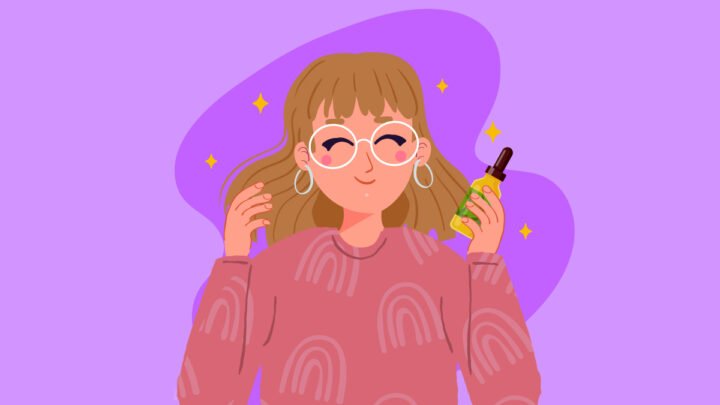 a woman holding a bottle of CBD oil