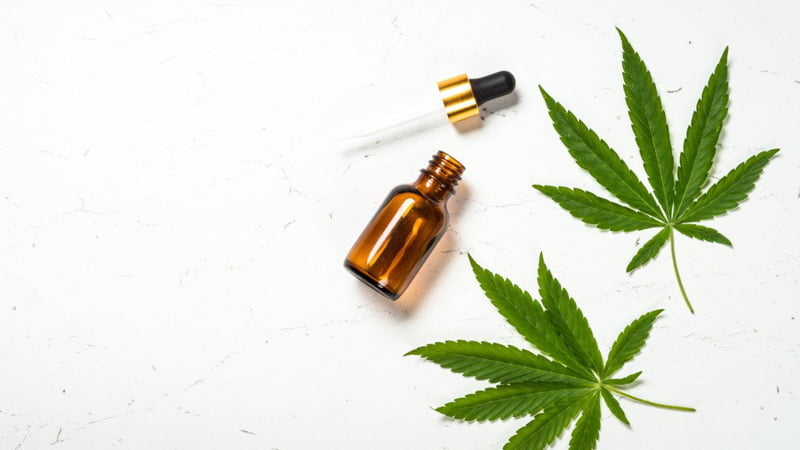 CBD Oil Bottle and Dropper with Hemp Leaves