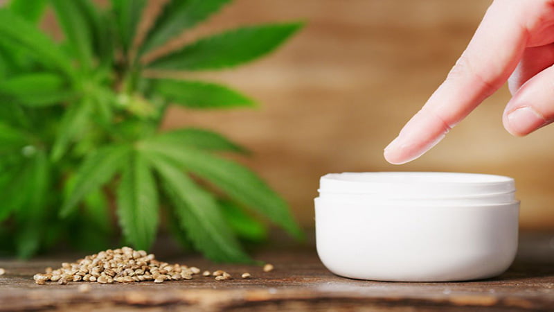 Hand Pointing into CBD Cream