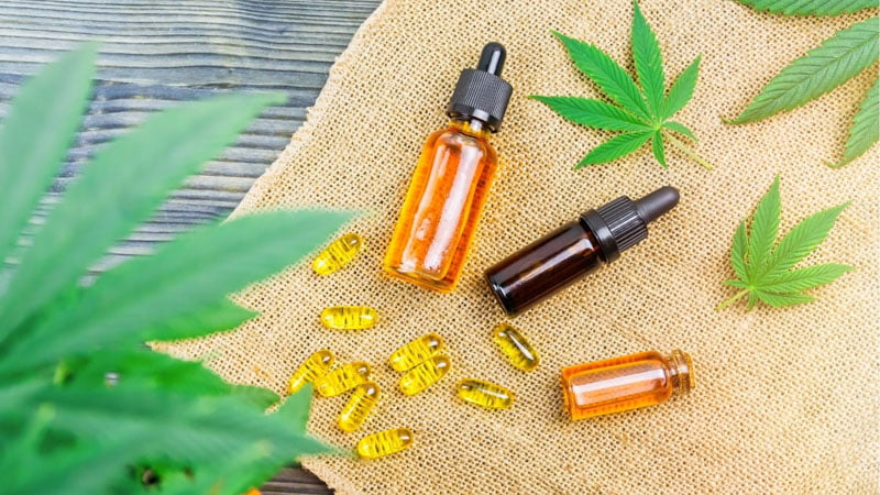 CBD Oil and Capsules with Hemp Leaves