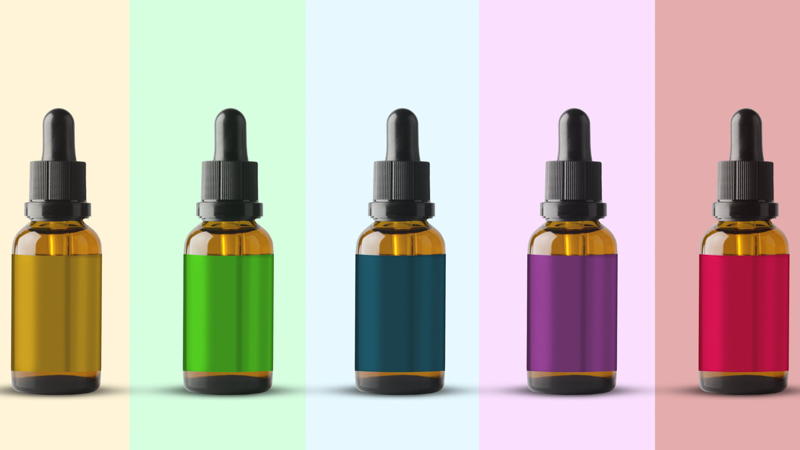 Five Bottles of CBD Oil in Different Color Label