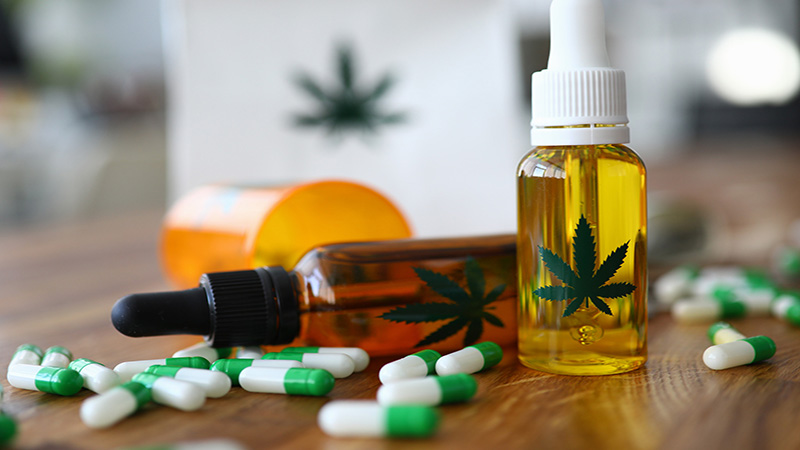 CBD Capsules and Oil Bottles on a Table