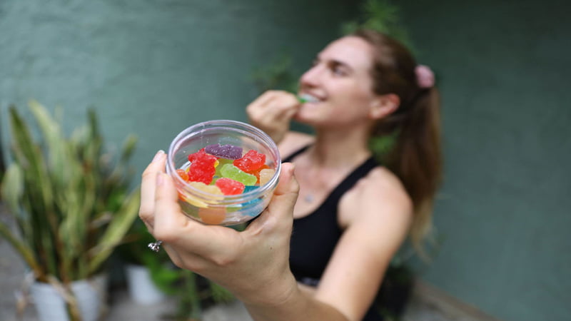 Woman Holding a Jar of Delta 8 THC Gummies