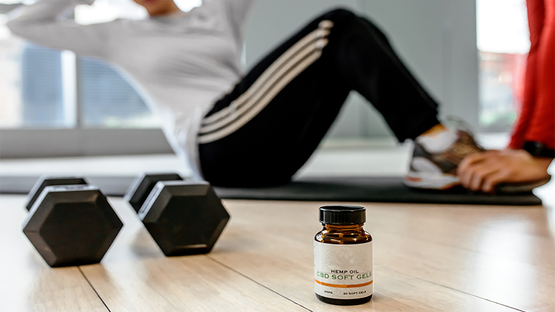 Woman Exercise with CBD Oil in Front Focused