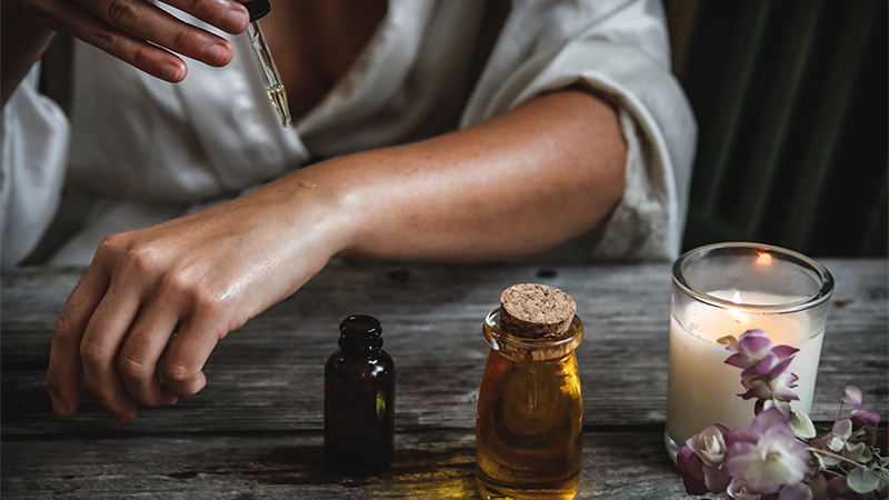 Woman Applying CBC/CBD Oil on Her Skin