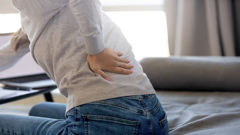 Woman Hand Pressing the Her Back Pain cause by Kidney Disease