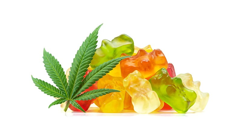 CBD-infused gummies and a hemp bud on white background