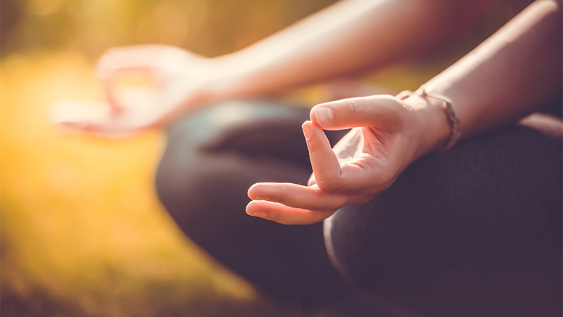 person sitting and meditating