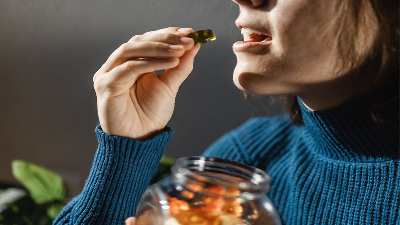 Woman eating a jar of gummies