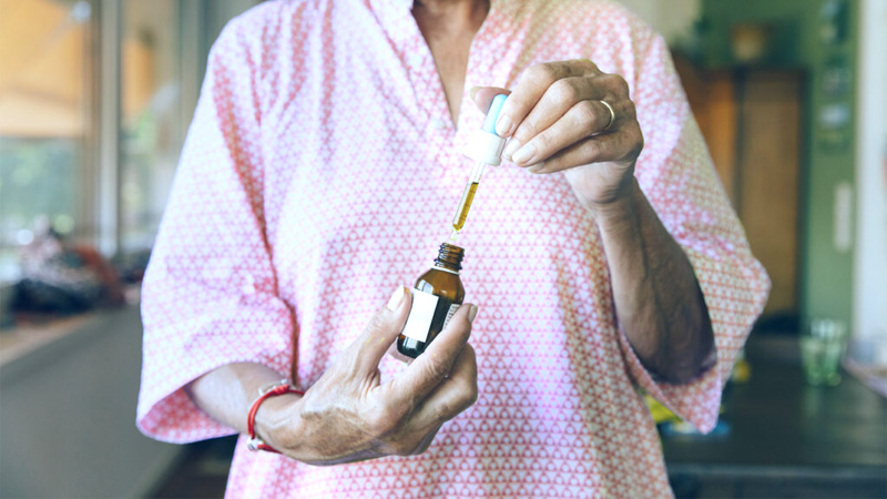 Patient holding a bottle of CBD oil