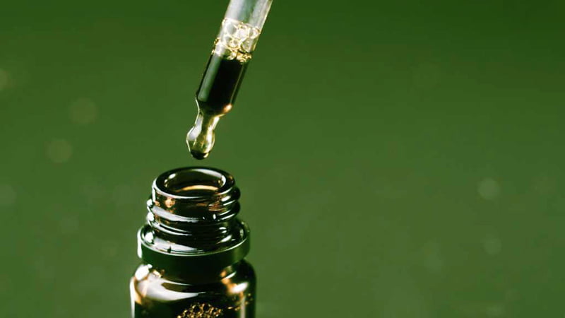 CBD oil dropping on bottle