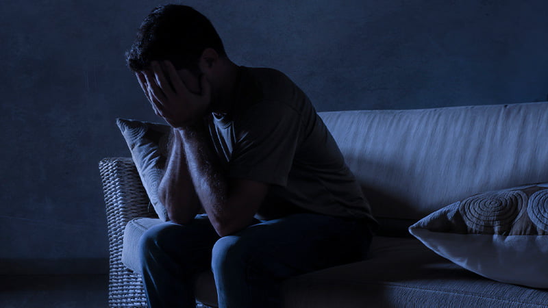 Man with anxiety sitting on the couch