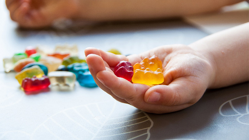 Image of hand holding cbd gummies