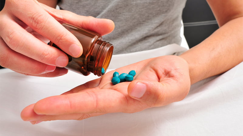 Man taking viagra pills while at bed