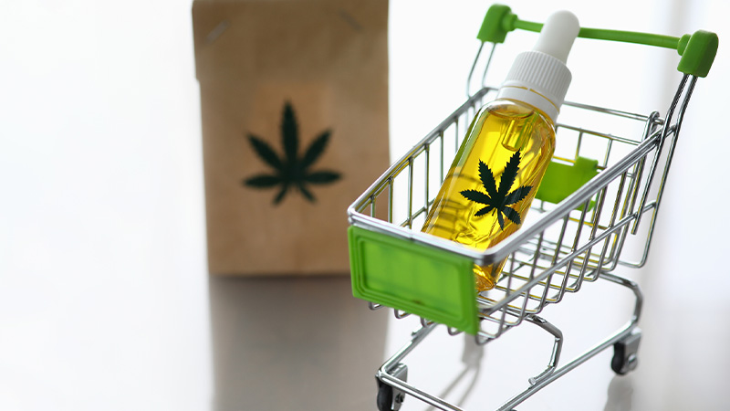 Image of a pus cart with C BD oil and an eco paper pack with hemp logo 