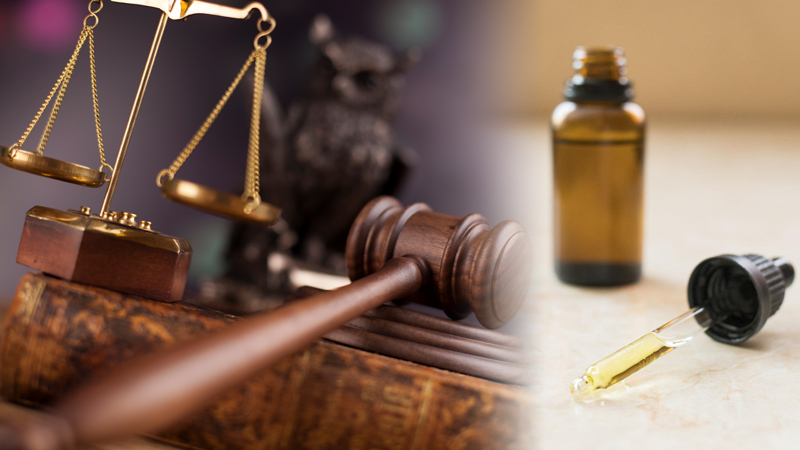A Gavel, Scale of Justice, and CBD oil bottle