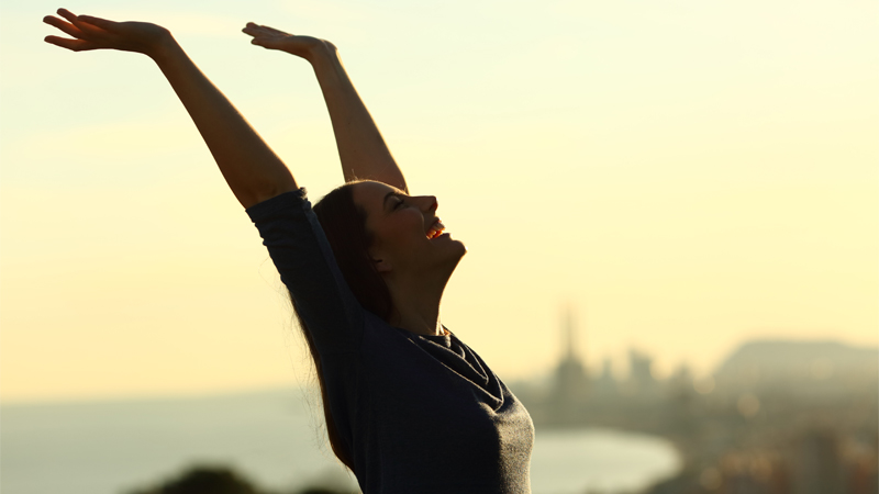 Woman raising her hands up