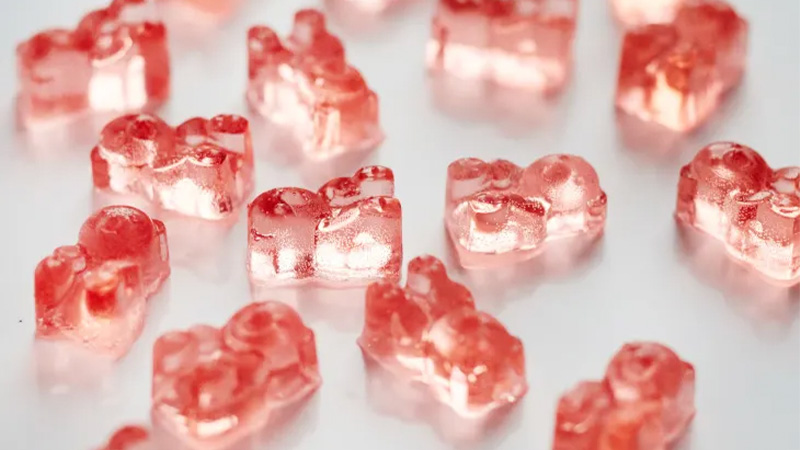 Pink-colored Delta 8 gummies in white background