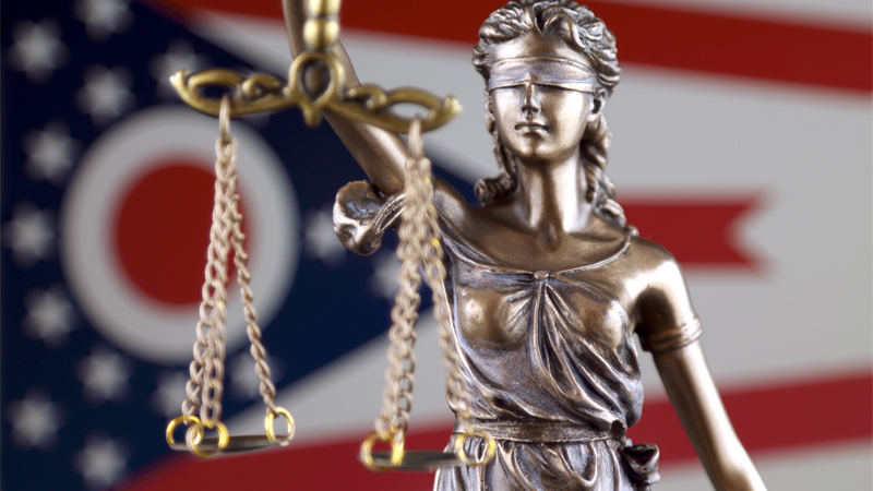 Flag of Ohio behind the lady of justice