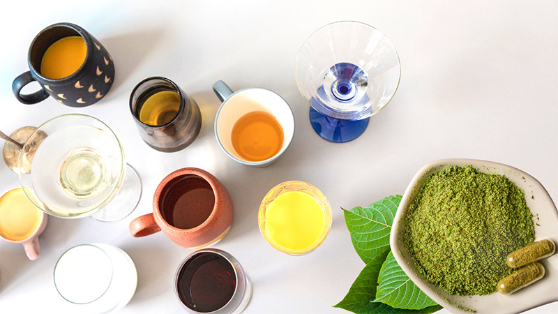 Various beverages with a saucer of kratom powder