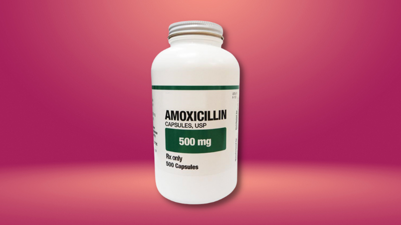 A bottle of Amoxicillin in red pink background