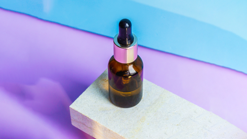 CBD oil bottle on top of a brick