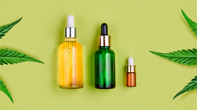 Three different sizes of CBD oil bottles with hemp leaves