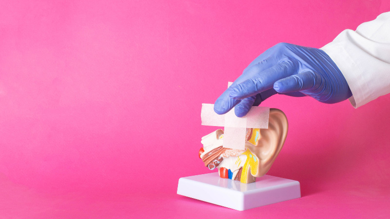 A mock up human ear on pink background